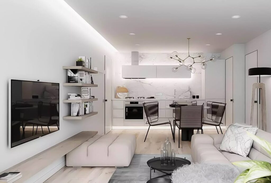 თანამედროვე სტილის პატარა ბინა: თეთრი კედლები, ღია ავეჯი და მინიმალური დეკორი.